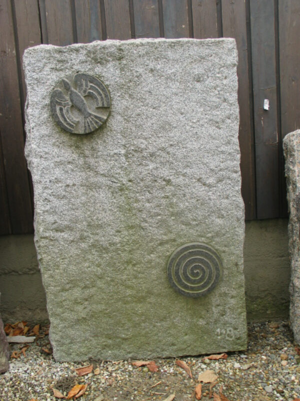 Grabmal mit eingesetzten Reliefen aus dunklem Granit